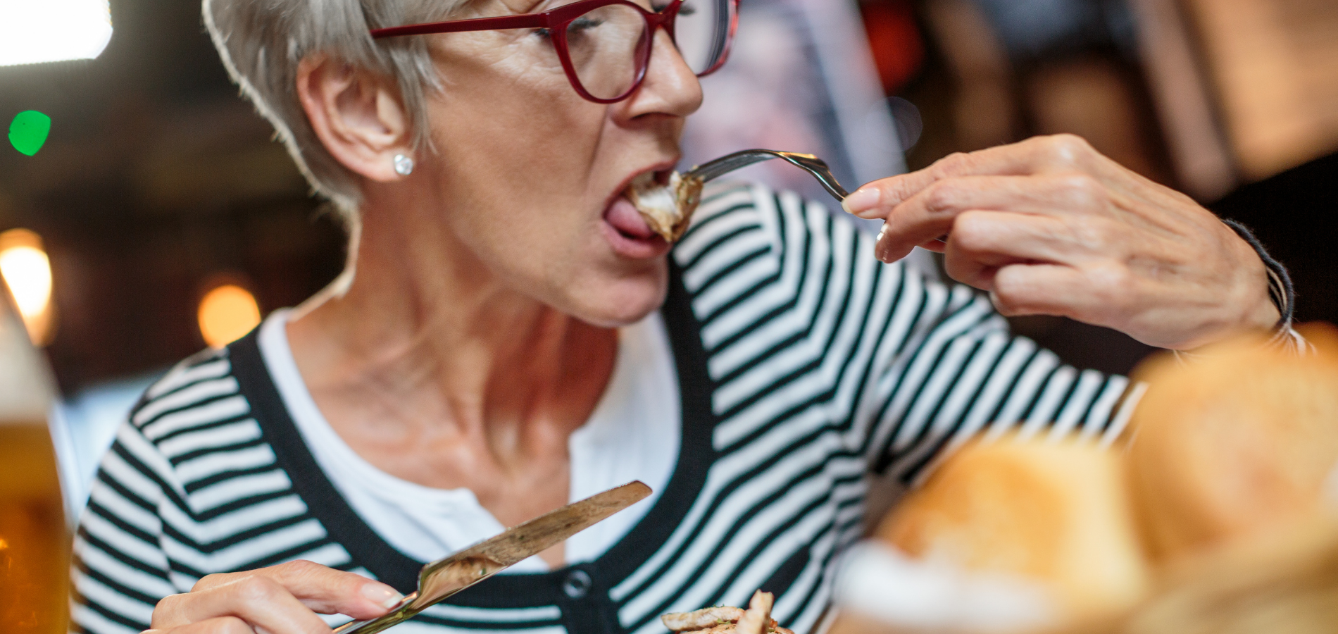 Woman eating a grilled pork in fork