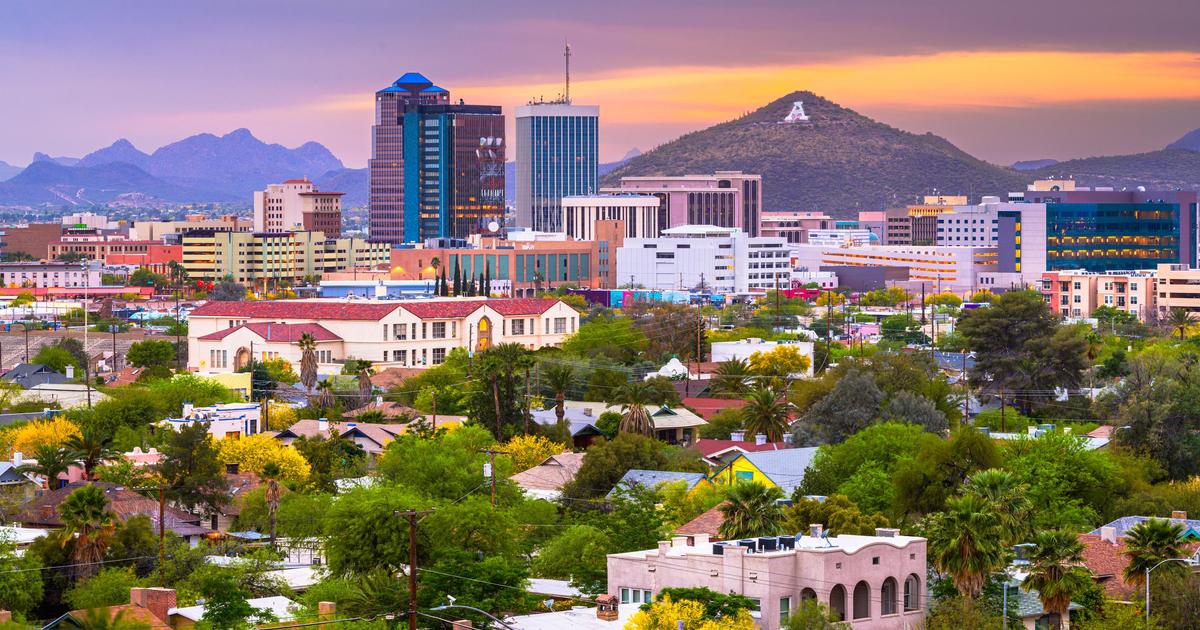 Colorful Tucson skyline at sunset with mountains and the letter "A" on a hill in Arizona