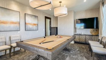 Indoor room with a pool table, modern lighting, wall art, and a flat-screen TV in Arizona